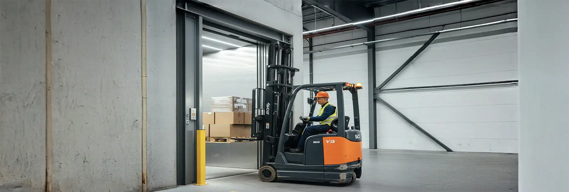 A forlift is loading goods in a freight lift